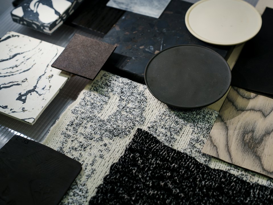 Stone, terrazzo and textile samples laid out on a table